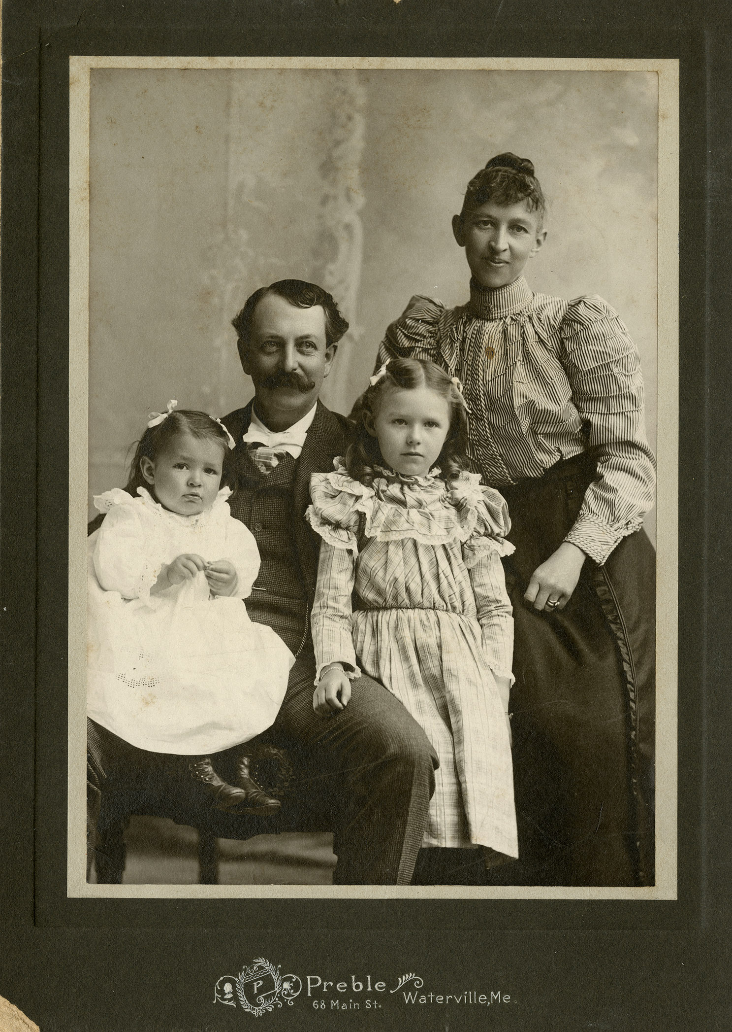 Card-mounted albumen print of a family, 1870-1890 (Human Development and Family Studies Photograph Collection)