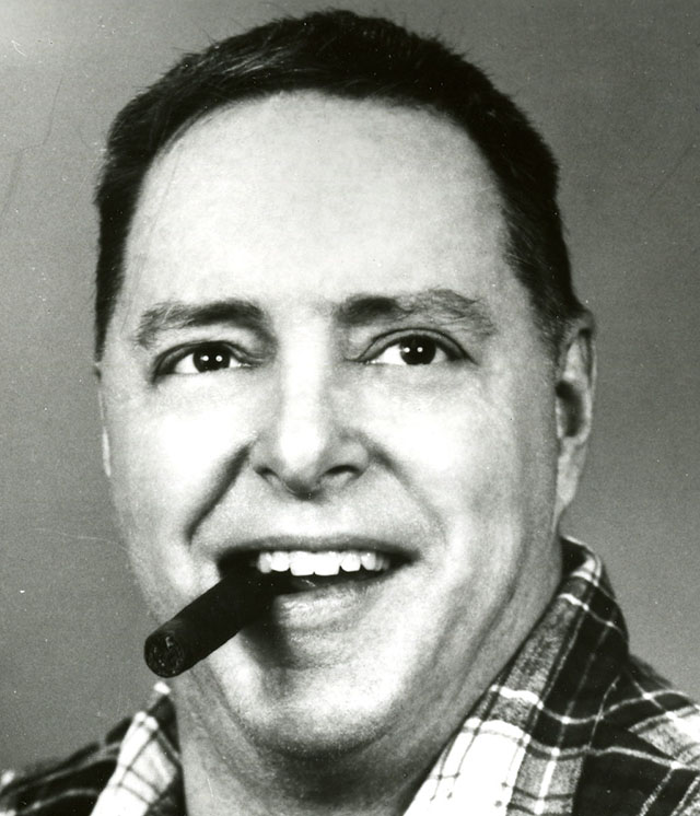 Image of Foster Gunnison, Jr. with a cigar in his mouth.